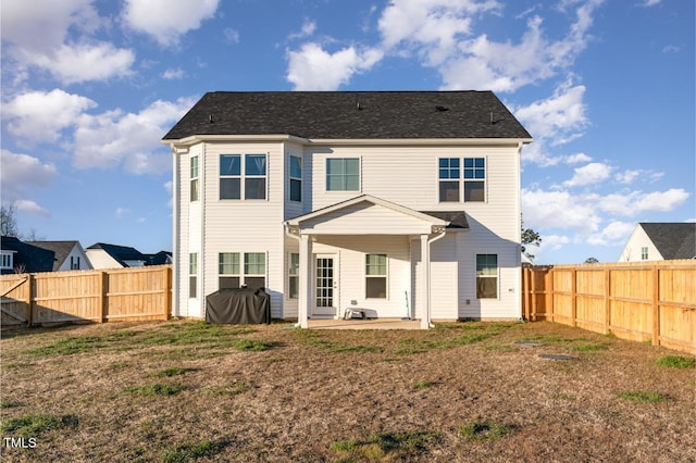 rear view of house featuring a patio area and a lawn