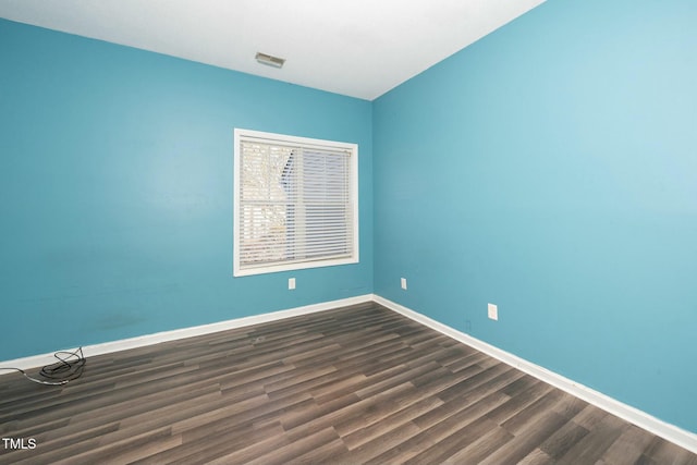 empty room featuring dark wood-type flooring