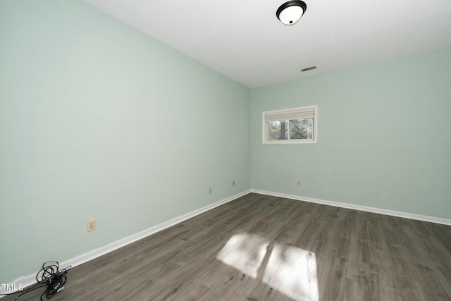 empty room with dark hardwood / wood-style floors