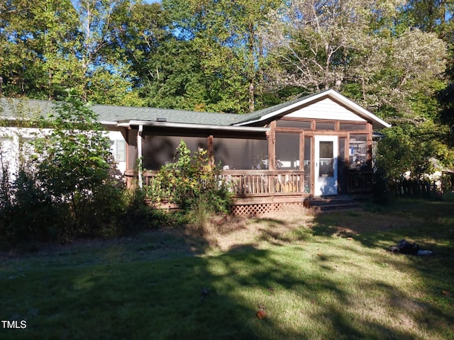 back of house with a lawn