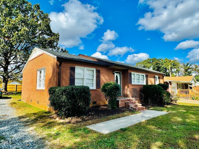 ranch-style home with a front lawn