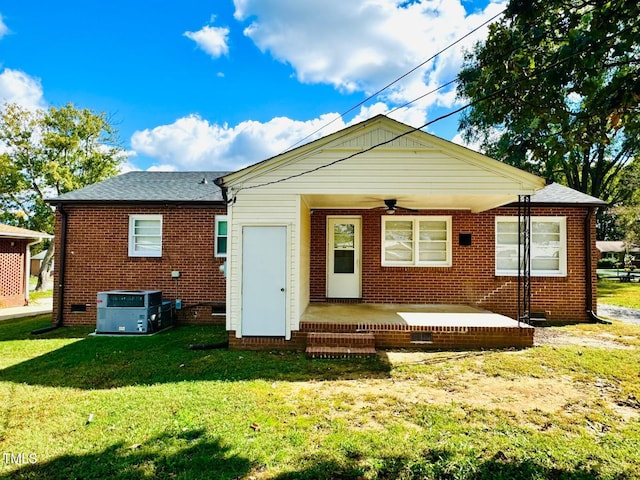 rear view of house featuring a patio area, central AC unit, and a yard