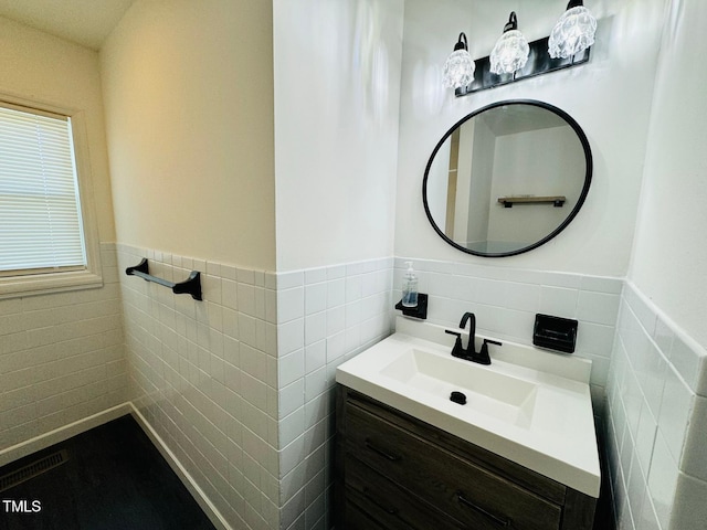 bathroom featuring tile walls and vanity