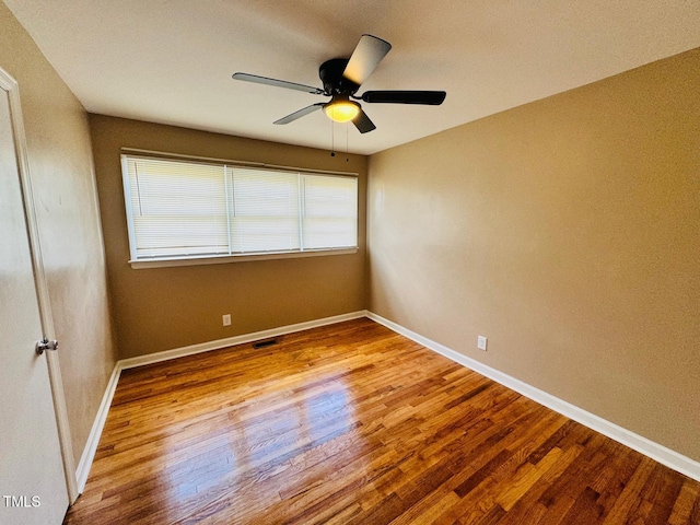 spare room featuring light wood-type flooring and ceiling fan