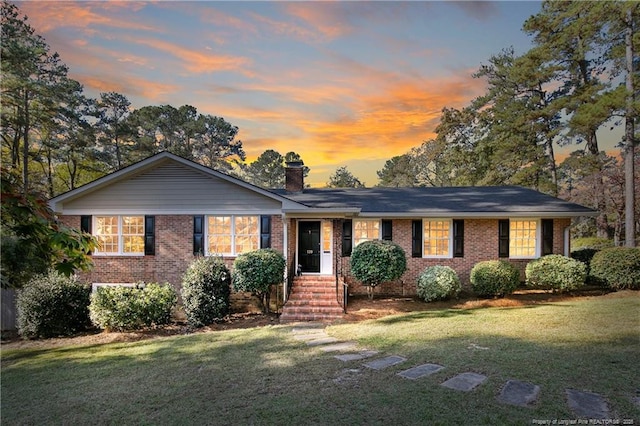 ranch-style house featuring a lawn