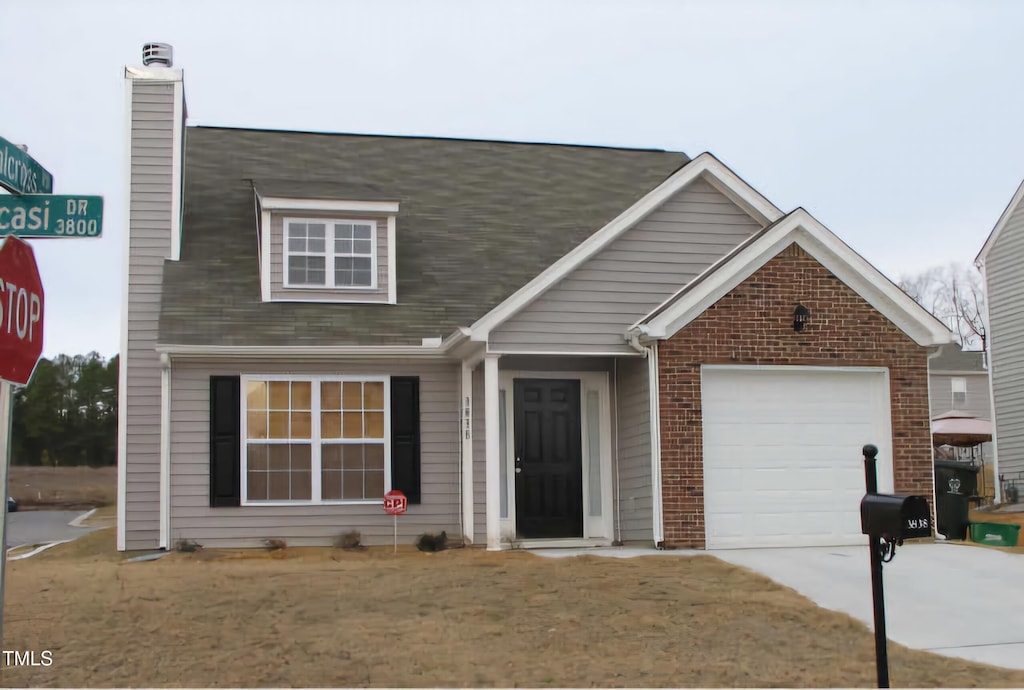 view of front of home with a garage and a front lawn