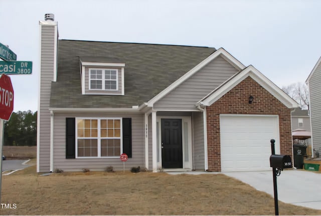 view of front of home with a garage and a front lawn