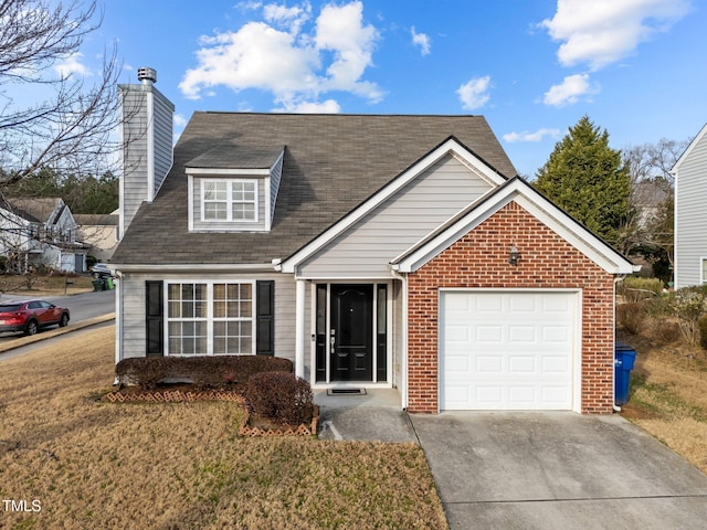 view of front of house featuring a garage and a front lawn