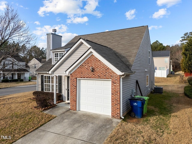 view of side of home featuring cooling unit, a garage, and a yard