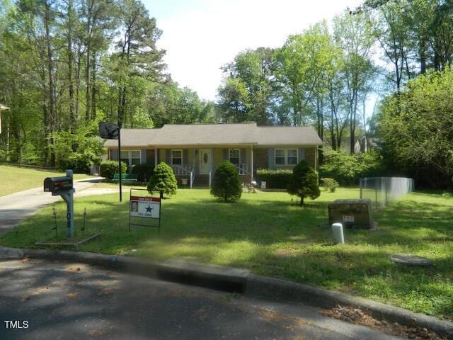108 Cheney Ct, Garner, NC 27529 - view of front of home with a porch, concrete driveway, and a front lawn