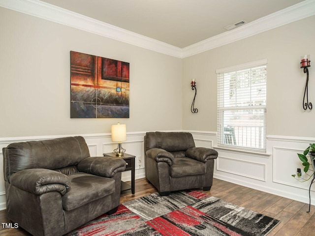 sitting room with dark hardwood / wood-style flooring and crown molding