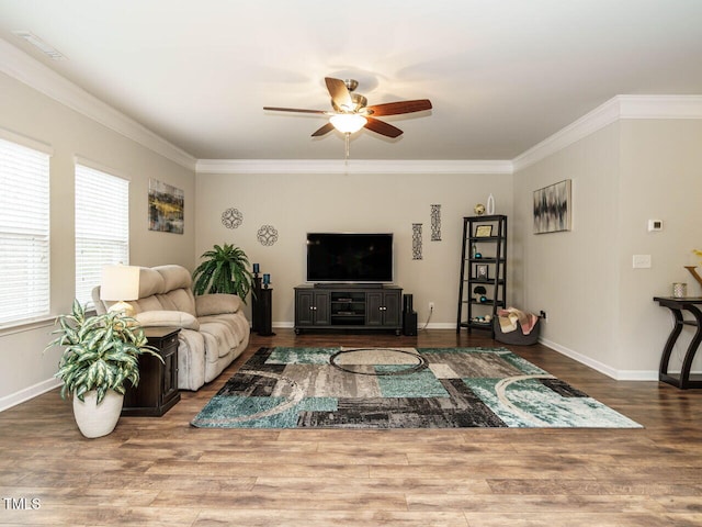 living room with wood-type flooring, ceiling fan, and crown molding