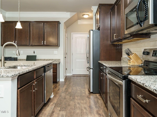 kitchen featuring light stone countertops, decorative light fixtures, stainless steel appliances, sink, and ornamental molding