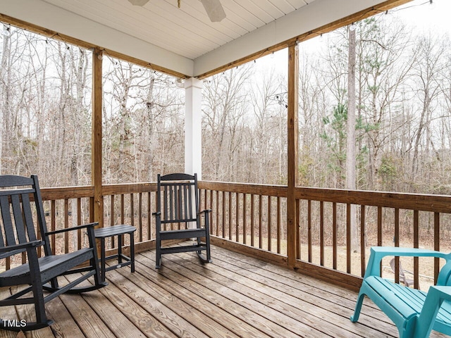 sunroom / solarium featuring a healthy amount of sunlight and ceiling fan