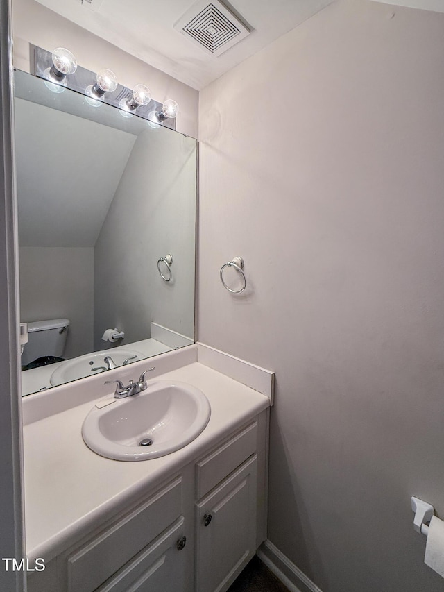 bathroom featuring vanity and toilet