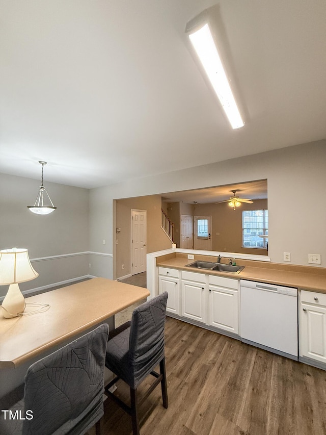 kitchen with decorative light fixtures, white cabinetry, dishwasher, wood-type flooring, and sink