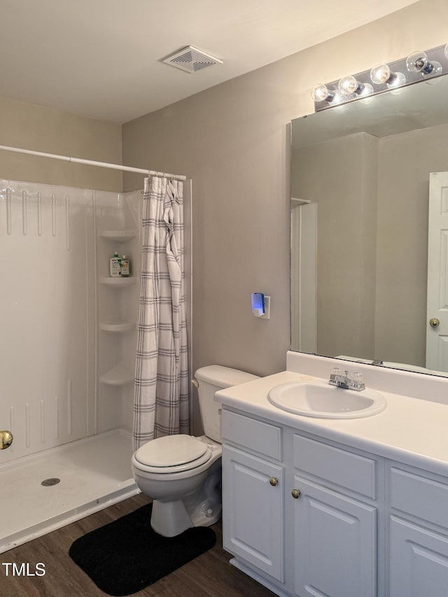 bathroom featuring hardwood / wood-style flooring, vanity, and curtained shower