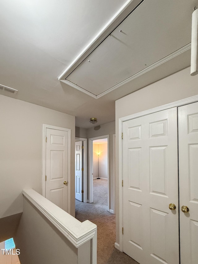 hall featuring dark colored carpet