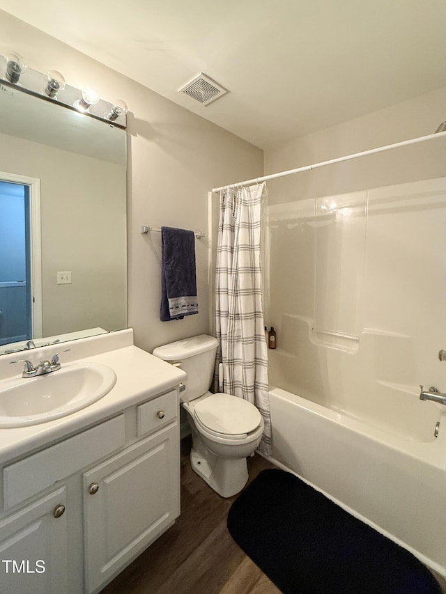 full bathroom with shower / bath combination with curtain, wood-type flooring, toilet, and vanity