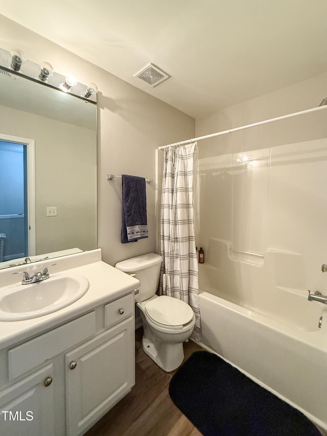 full bathroom with hardwood / wood-style flooring, vanity, toilet, and shower / bath combo with shower curtain