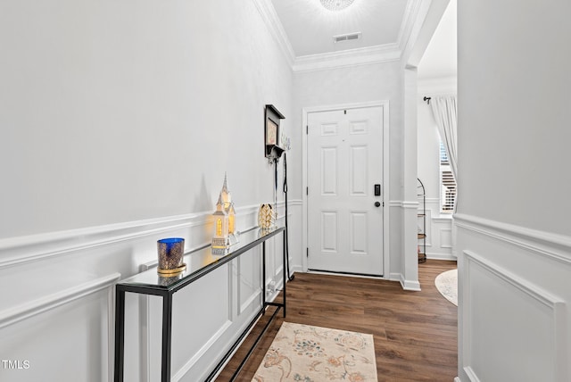 doorway with ornamental molding and dark wood-type flooring