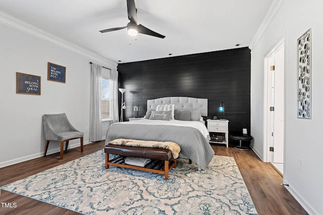 bedroom featuring hardwood / wood-style floors, crown molding, wooden walls, and ceiling fan