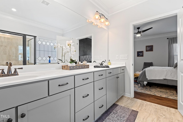 bathroom with vanity, ornamental molding, ceiling fan, and walk in shower