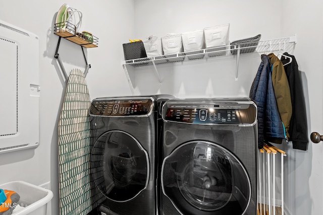 clothes washing area featuring washer and dryer