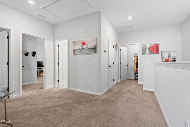 hall with light colored carpet