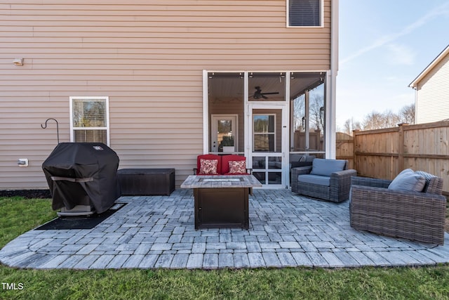 view of patio / terrace with grilling area, an outdoor fire pit, and a sunroom