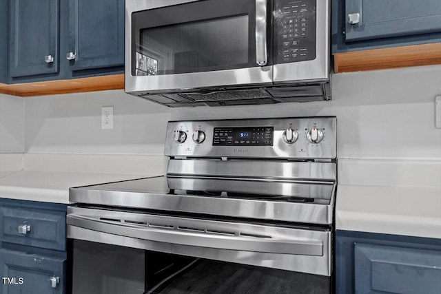 kitchen featuring stainless steel appliances and blue cabinets