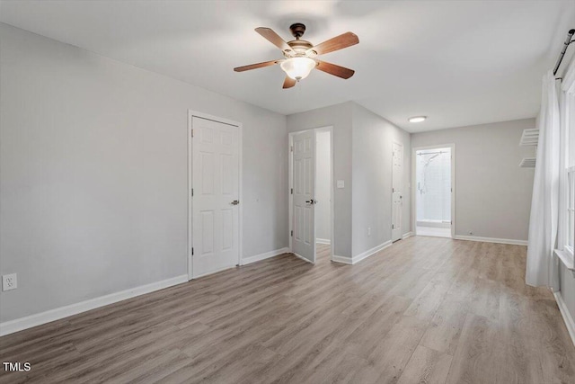 empty room featuring ceiling fan and light wood-type flooring