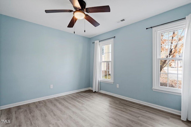 empty room featuring ceiling fan and light hardwood / wood-style floors