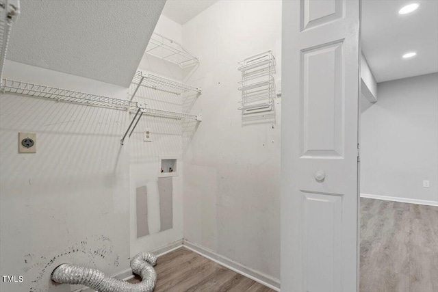 washroom featuring hardwood / wood-style floors, electric dryer hookup, and washer hookup