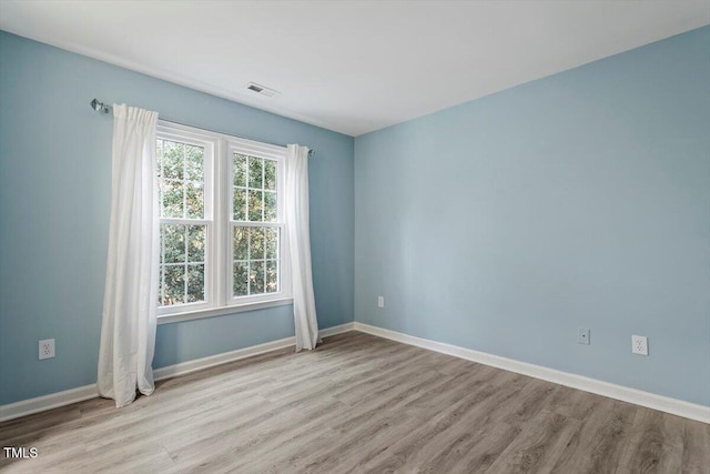 empty room with light hardwood / wood-style floors