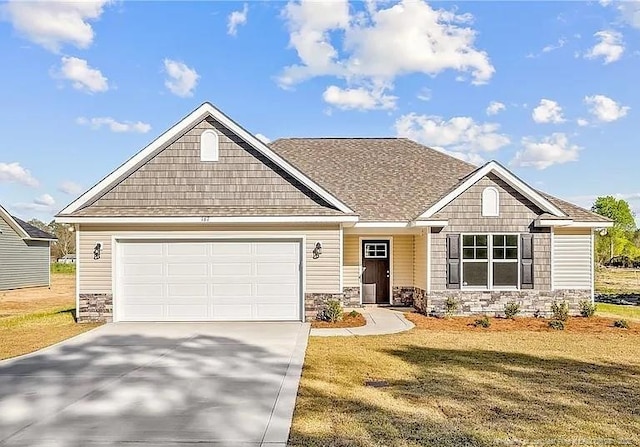 craftsman-style home featuring a garage and a front yard