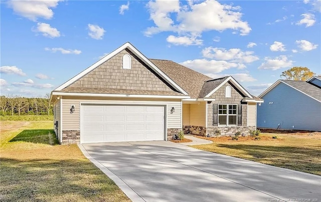 craftsman inspired home featuring a garage and a front lawn