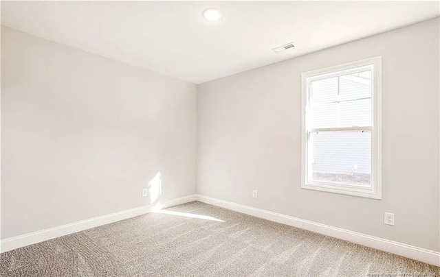 spare room with plenty of natural light and carpet