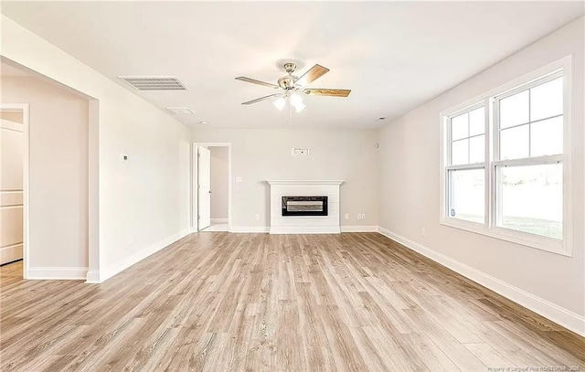 unfurnished living room with ceiling fan and light wood-type flooring