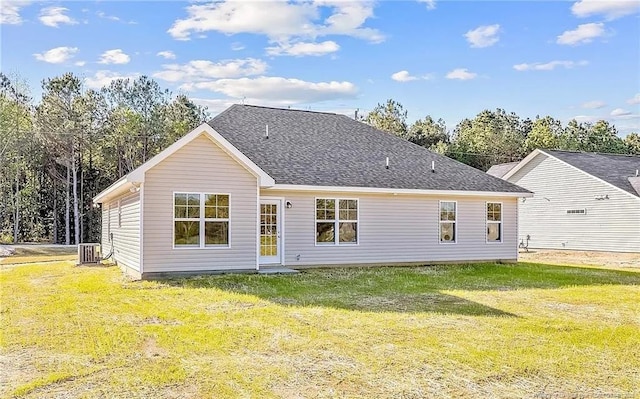 back of property featuring a lawn and central AC