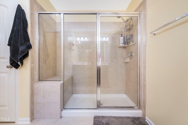 bathroom featuring a shower with shower door and tile patterned floors