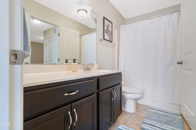 bathroom with vanity, toilet, and tile patterned floors