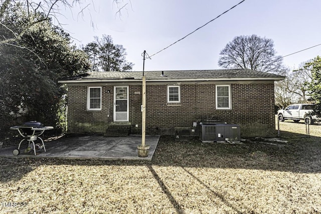 rear view of house with a patio area and central AC