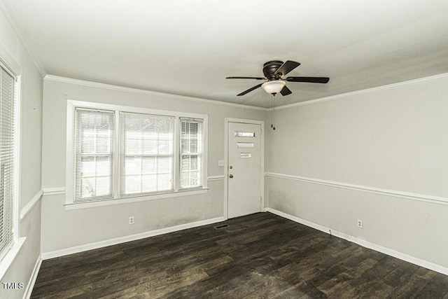 spare room with a healthy amount of sunlight, crown molding, and dark hardwood / wood-style floors