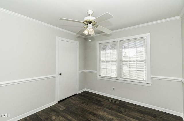 spare room featuring ceiling fan, crown molding, and dark hardwood / wood-style flooring