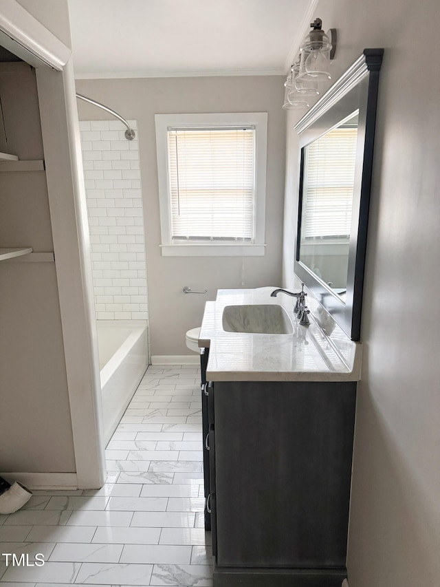 full bathroom featuring ornamental molding, toilet, tiled shower / bath, and vanity