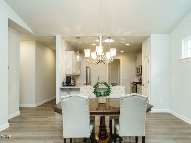 dining room featuring light hardwood / wood-style floors and a notable chandelier