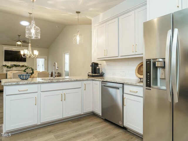 kitchen with decorative backsplash, sink, white cabinetry, and stainless steel appliances