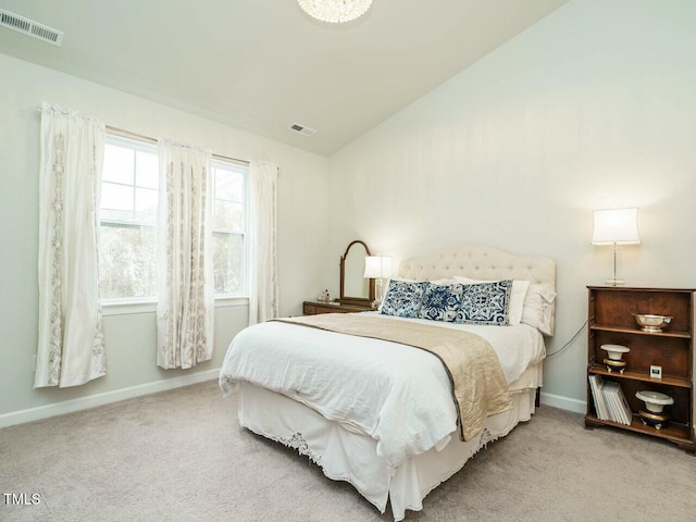 bedroom with light carpet and vaulted ceiling