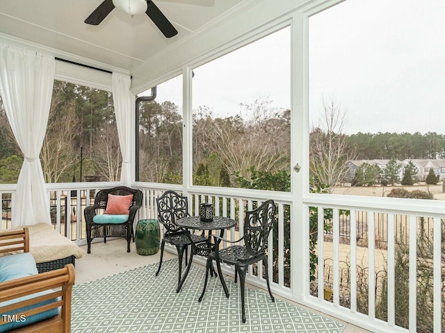 sunroom featuring ceiling fan